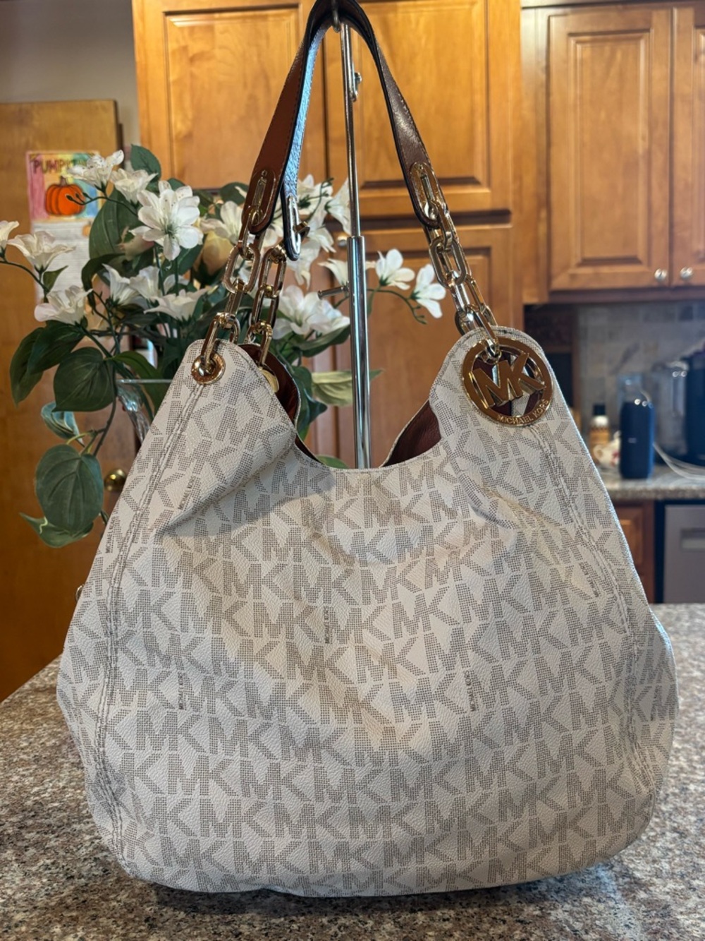 Michael Kors Fulton Large Chain Shoulder Tote in a vanilla MK pattern with Brown
